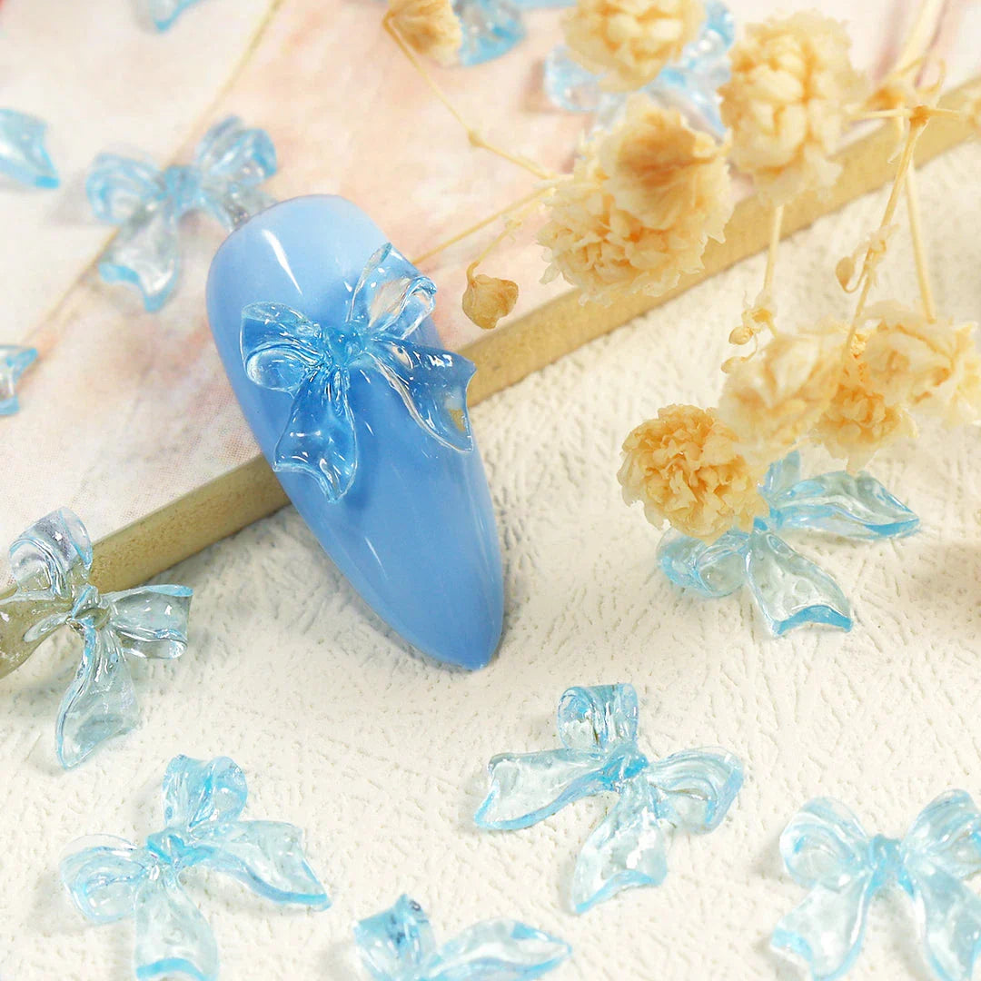 Charming candy-coloured bow nail charms in various colours, perfect for adding a playful touch to your manicure