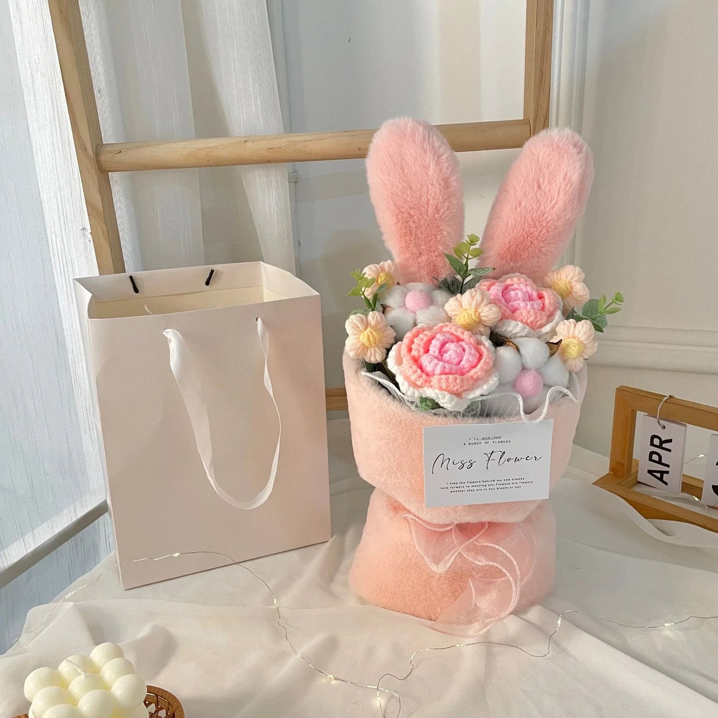 A delightful knitted rabbit bouquet doll in vibrant colours, featuring soft plush materials and a charming design