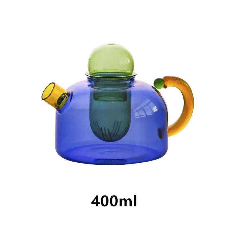 Elegant glass teapot and teacup set in vibrant contrasting colours, designed for a refined tea experience