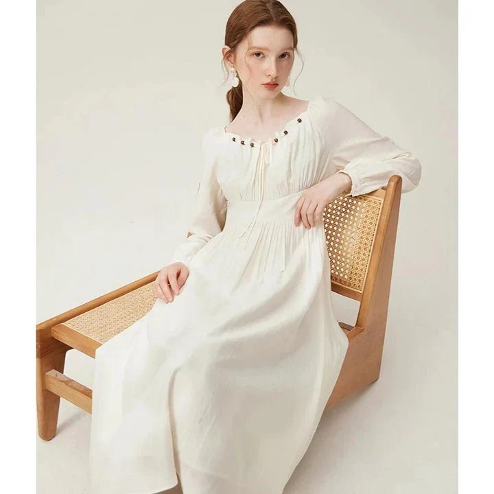 Elegant Chinese-style dress with empire waistline, full-length sleeves, and midi length for a timeless, sophisticated look.