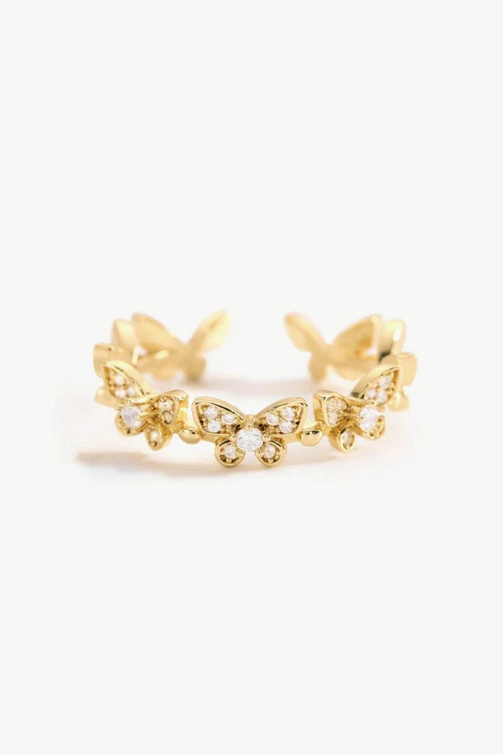 Elegant gold-toned open ring with a captivating butterfly design accented by sparkling zircon stones