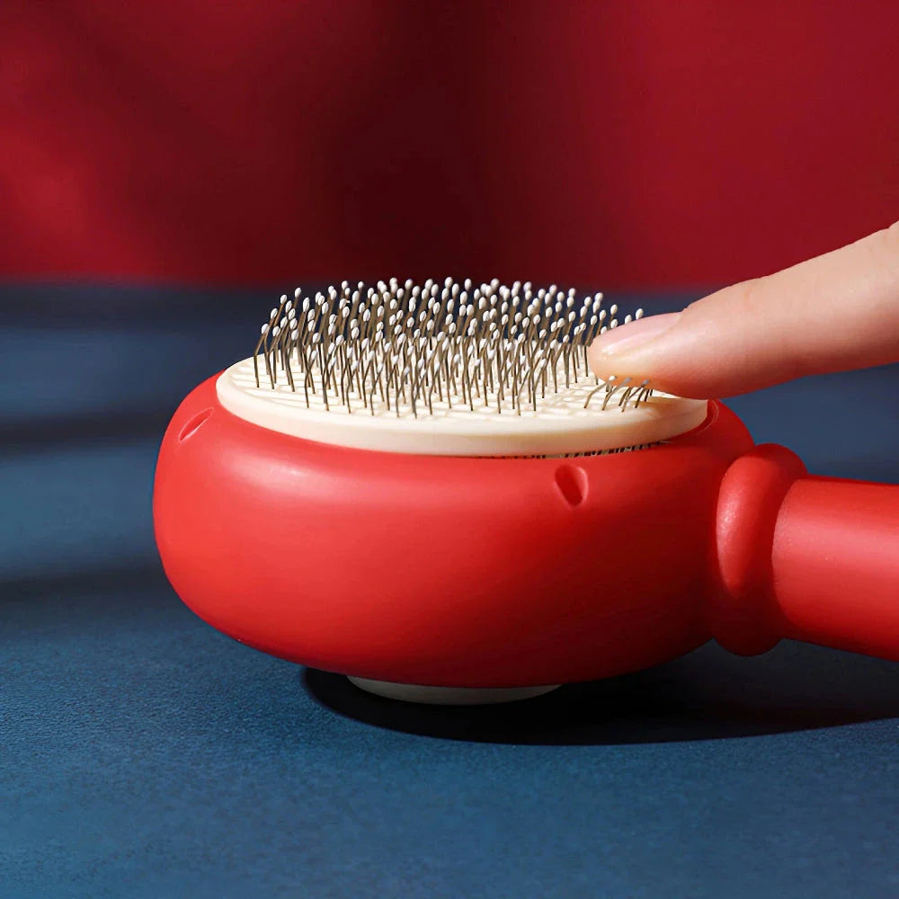One-Click Pet Hair Removal Comb in red colour, designed to effectively remove loose fur and tangles from cat or dog coats