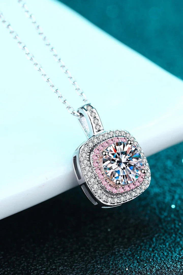 A rhodium-plated sterling silver necklace with a geometric pendant featuring a sparkling Moissanite gemstone over 0.3 carats.