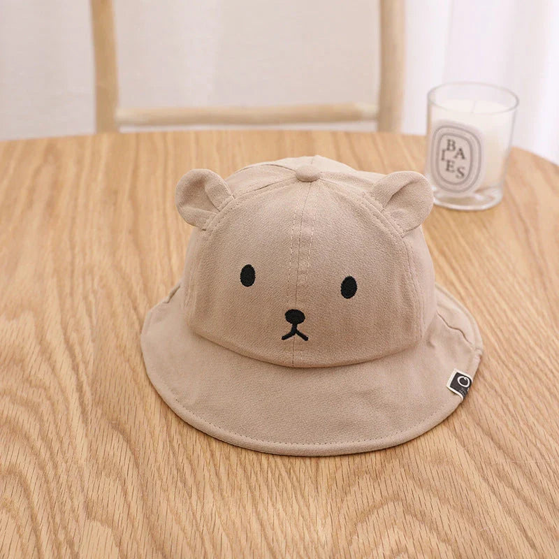 Adorable baby sun hat with cute bear ears, made of soft cotton and durable polyester for sun protection and comfort.