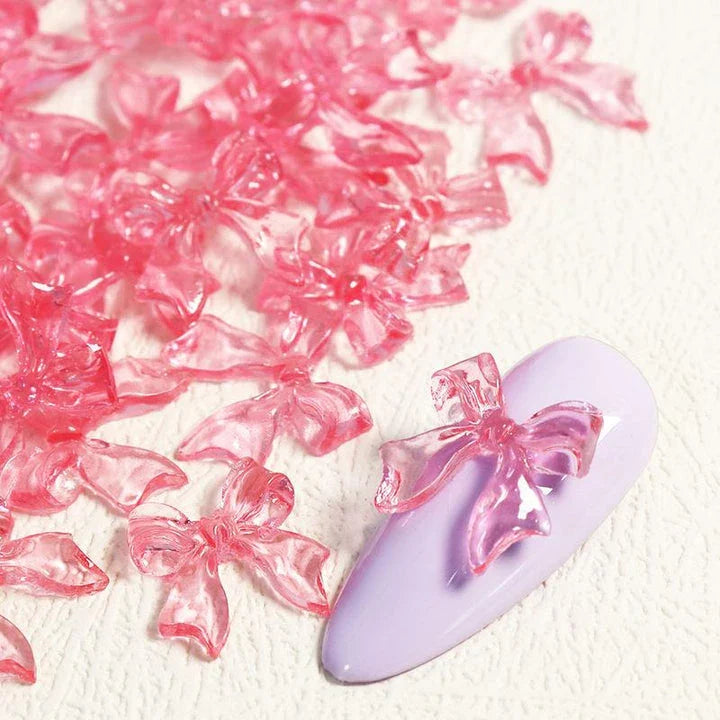 Charming candy-coloured bow nail charms in various colours, perfect for adding a playful touch to your manicure