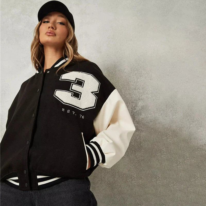 A classic British-style baseball jacket with contrast PU stitching, showcasing a sophisticated and versatile design for casual wear.
