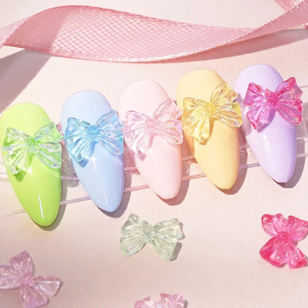 Charming candy-coloured bow nail charms in various colours, perfect for adding a playful touch to your manicure
