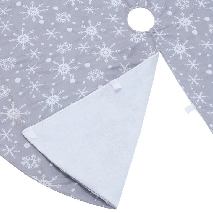 Grey background with intricate white snowflake design Christmas tree skirt