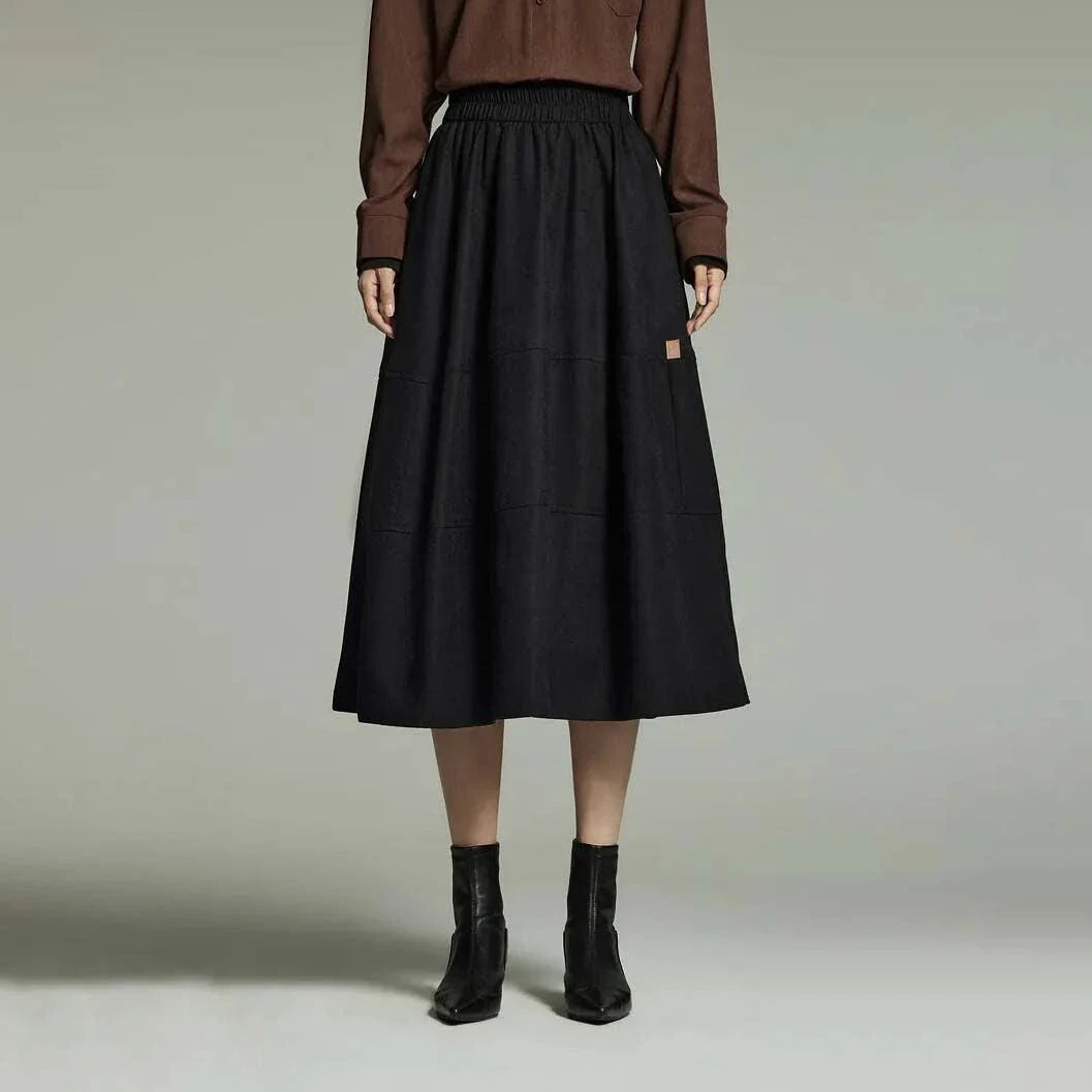 A stylish and sophisticated mid-length A-line pleated skirt with pockets, crafted from high-quality twill fabric for durability and comfort.