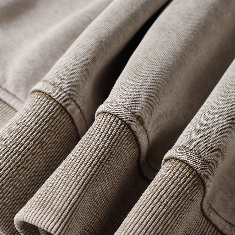 A premium cotton pullover hoodie with an embroidered letter patch in a variety of classic autumn colours