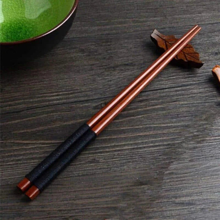 Pair of natural chestnut wood chopsticks with a rustic, earthy tone and elegant design