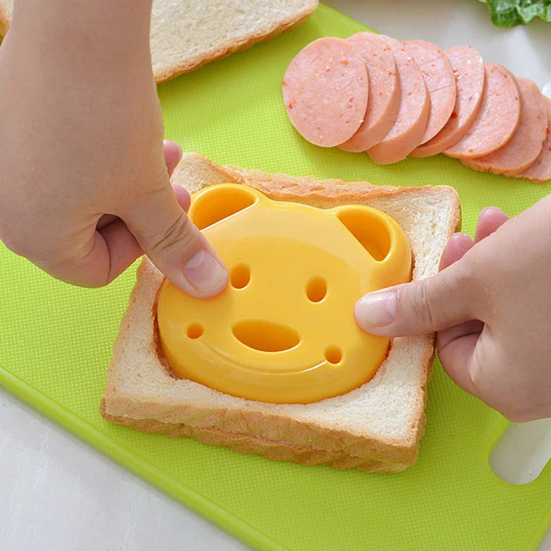 A yellow bear-shaped sandwich cutter used to create fun, creative sandwiches for children