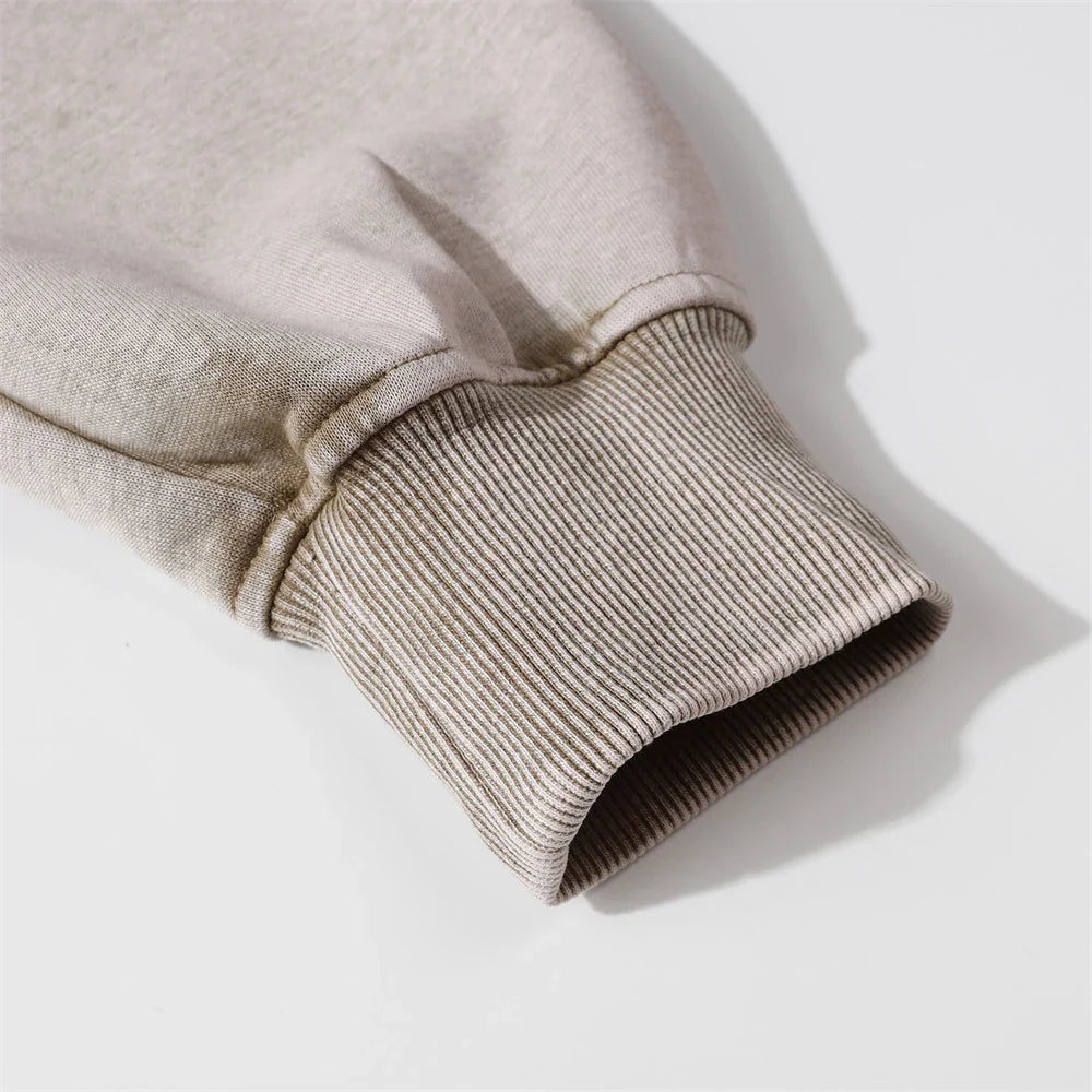 A premium cotton pullover hoodie with an embroidered letter patch in a variety of classic autumn colours