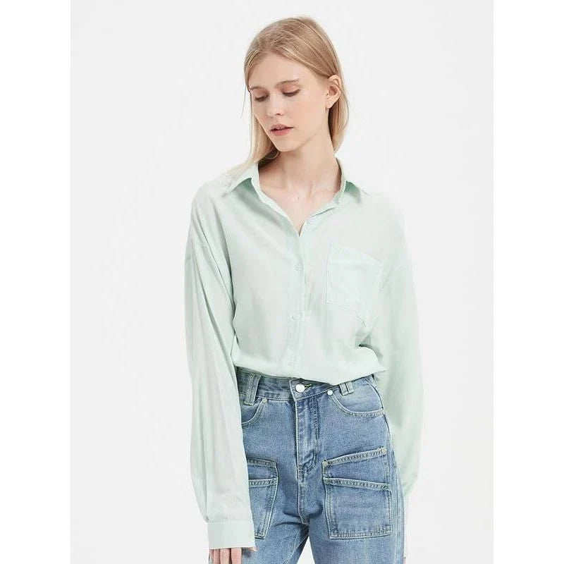 A classic long-sleeve button-up blouse in a range of chic colours, offering timeless elegance and modern sophistication for the fashion-conscious woman.