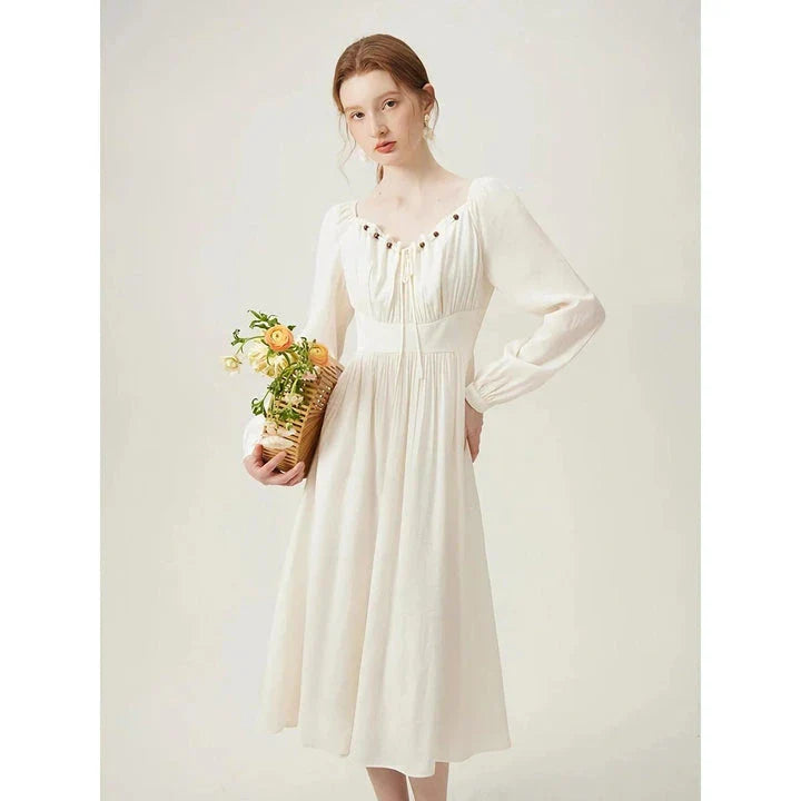 Elegant Chinese-style dress with empire waistline, full-length sleeves, and midi length for a timeless, sophisticated look.