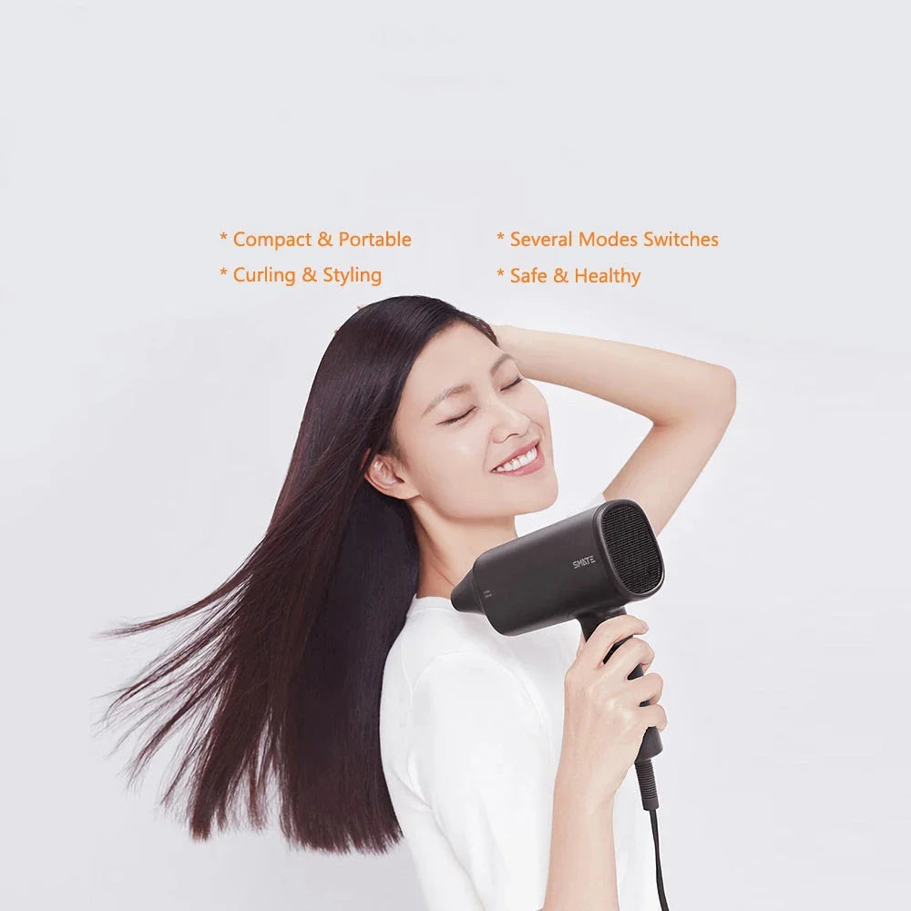 Compact and portable hair dryer with foldable handle, two-speed settings, and multiple nozzle positions for versatile styling