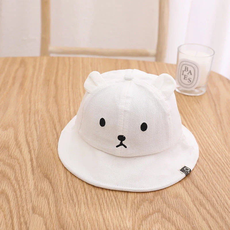 Adorable baby sun hat with cute bear ears, made of soft cotton and durable polyester for sun protection and comfort.