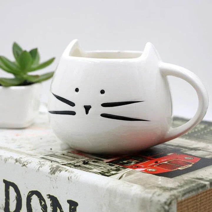 Charming black cat-shaped ceramic coffee mug with a spoon, a practical and whimsical addition to any coffee lover's collection