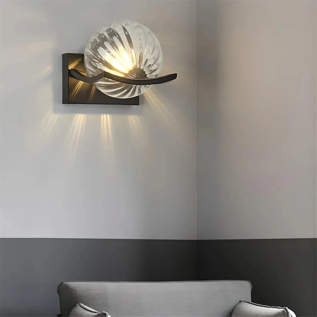 Modern black iron wall lamp with clear glass shade and LED lighting for a sophisticated look