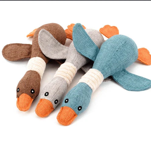 A soft, plush duck toy designed for dogs, featuring a squeaky component to encourage playful interaction.