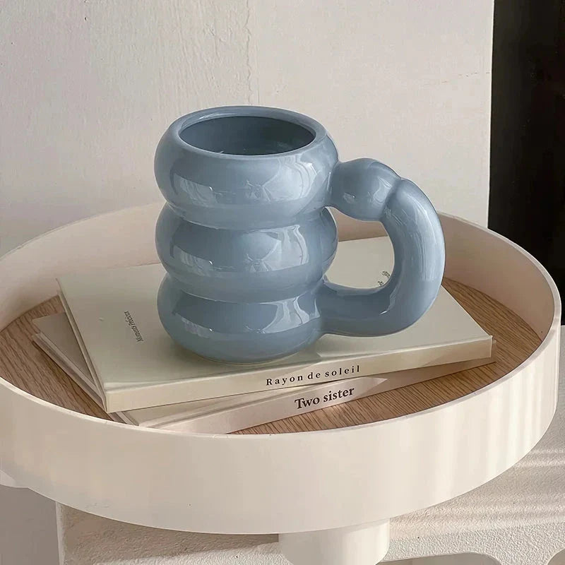 Charming ceramic coffee mug with a circular bubble design in a light blue colour, perfect for morning beverages in the UK