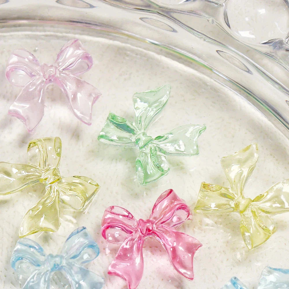 Charming candy-coloured bow nail charms in various colours, perfect for adding a playful touch to your manicure