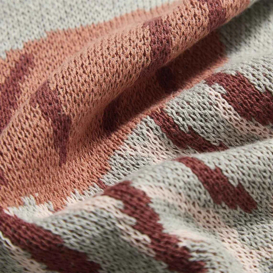 Cosy jellyfish-patterned cotton knit throw blanket in green and grey colours, showcasing its soft, plush texture and unique design.