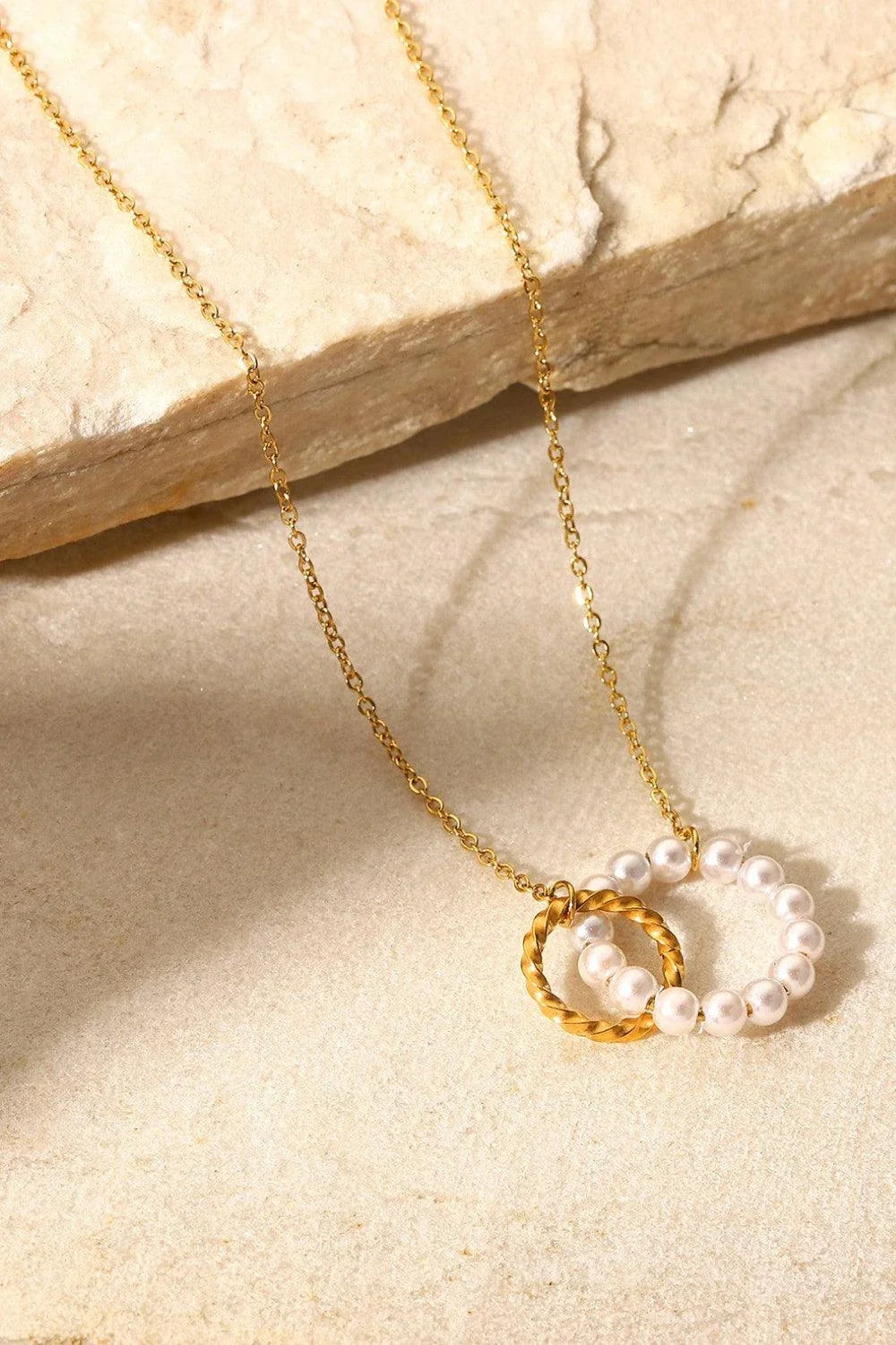 Elegant 18K gold-plated pearl hoop necklace with a lustrous synthetic pearl centrepiece