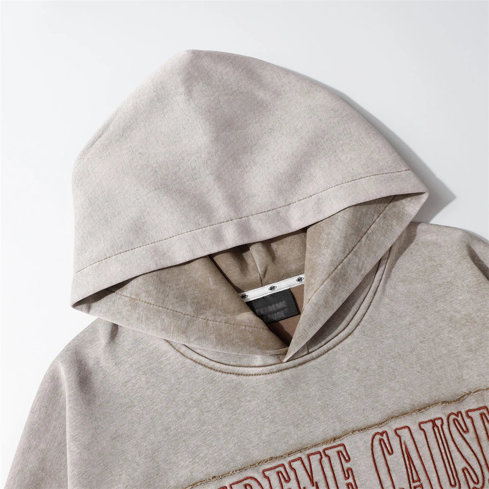 A premium cotton pullover hoodie with an embroidered letter patch in a variety of classic autumn colours
