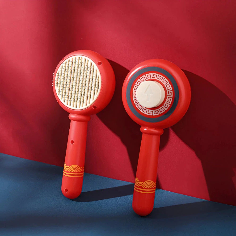 One-Click Pet Hair Removal Comb in red colour, designed to effectively remove loose fur and tangles from cat or dog coats
