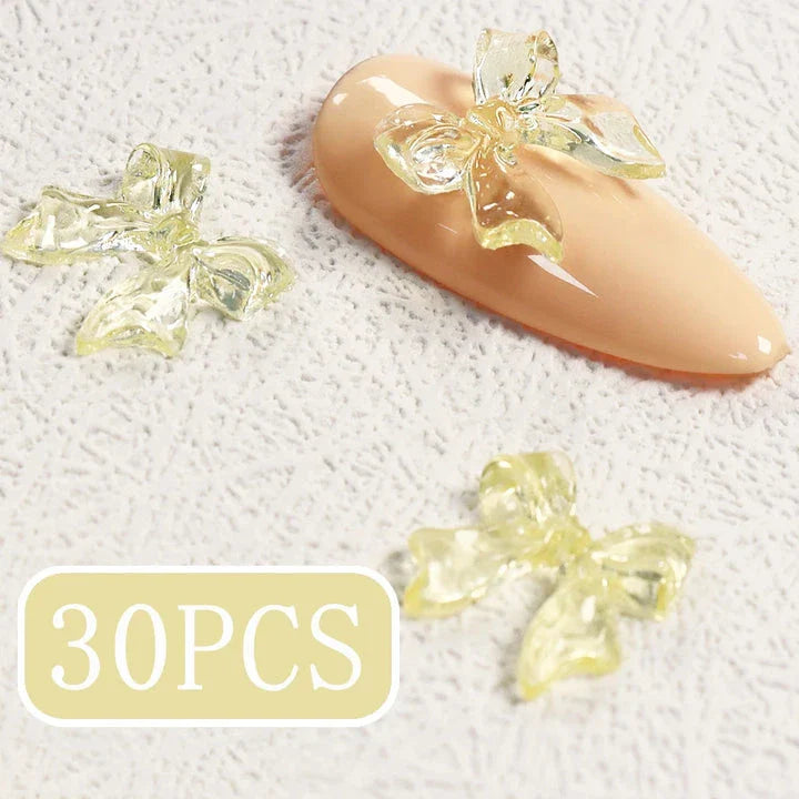 Charming candy-coloured bow nail charms in various colours, perfect for adding a playful touch to your manicure