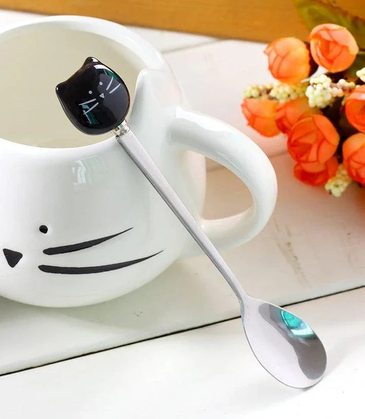 Charming black cat-shaped ceramic coffee mug with a spoon, a practical and whimsical addition to any coffee lover's collection