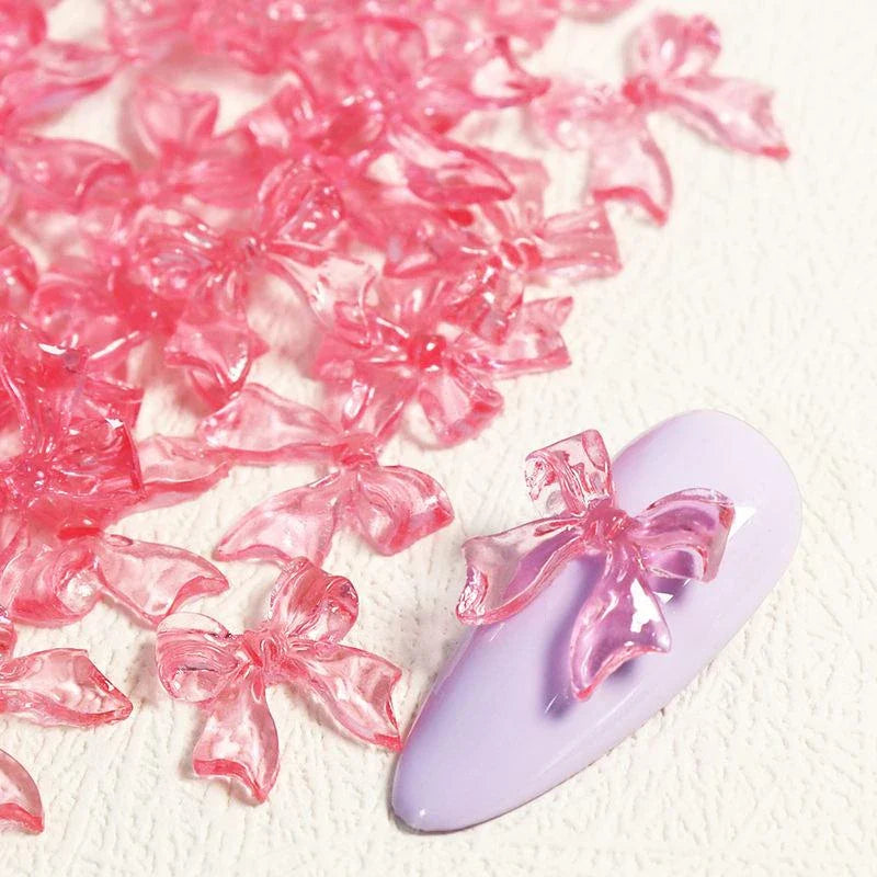 Charming candy-coloured bow nail charms in various colours, perfect for adding a playful touch to your manicure