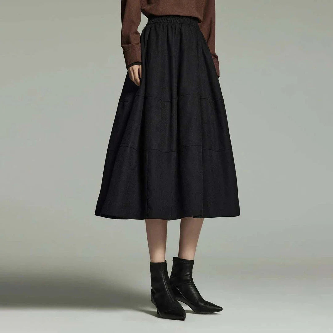 A stylish and sophisticated mid-length A-line pleated skirt with pockets, crafted from high-quality twill fabric for durability and comfort.
