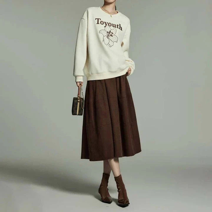 A stylish and sophisticated mid-length A-line pleated skirt with pockets, crafted from high-quality twill fabric for durability and comfort.