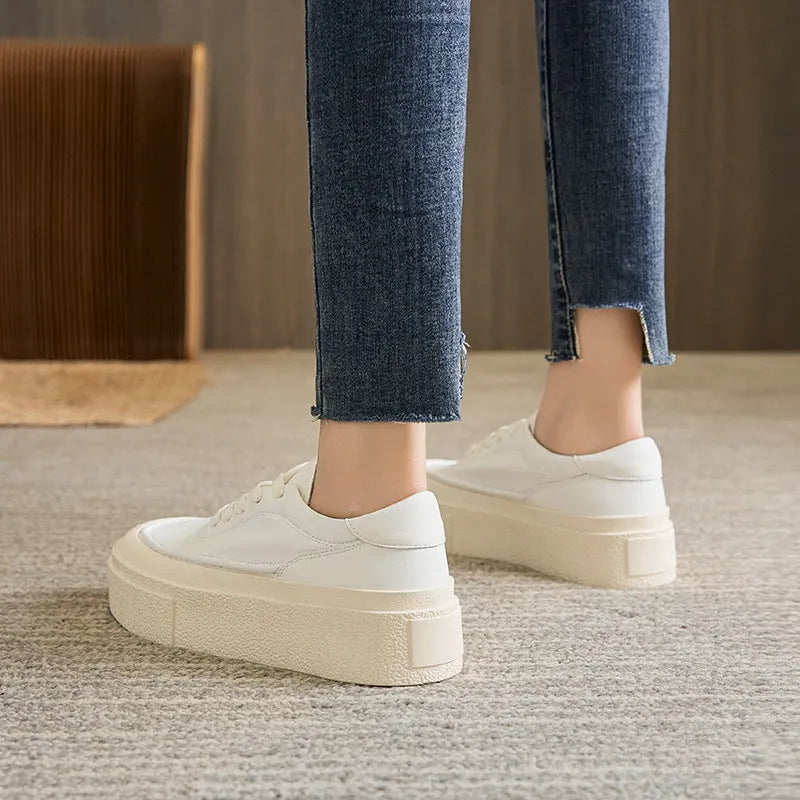 Women's black platform casual shoes with round toe and tied laces on a rubber sole.