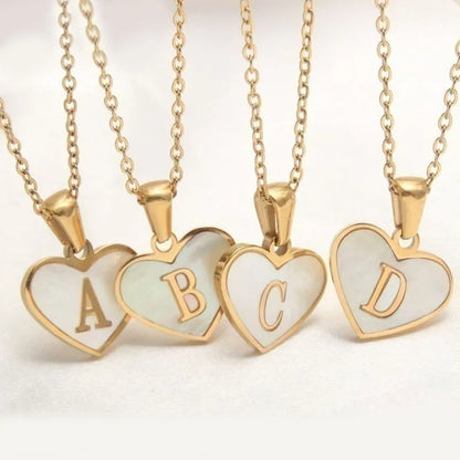 Gold-plated heart necklace with white shell pendant showing letter personalisation option