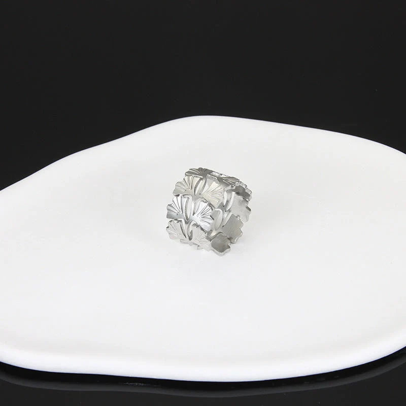 Adjustable stainless steel finger ring with unique charm designs in steel and gold finishes