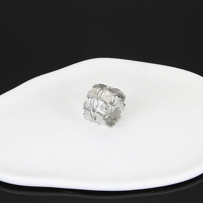 Adjustable stainless steel finger ring with unique charm designs in steel and gold finishes