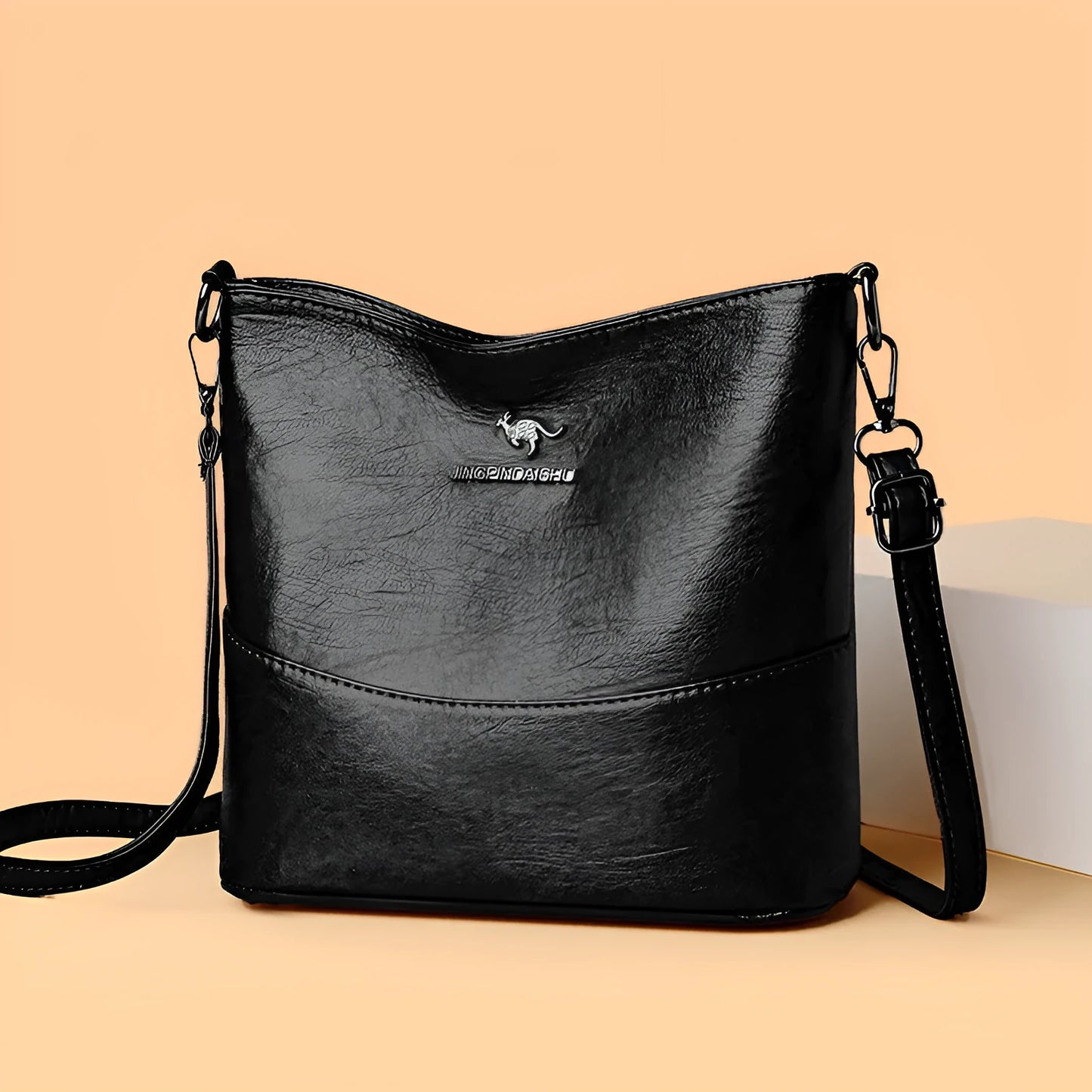 Women's soft leather bucket shoulder bag in black, wine red, or ginger yellow with large capacity and minimalist design