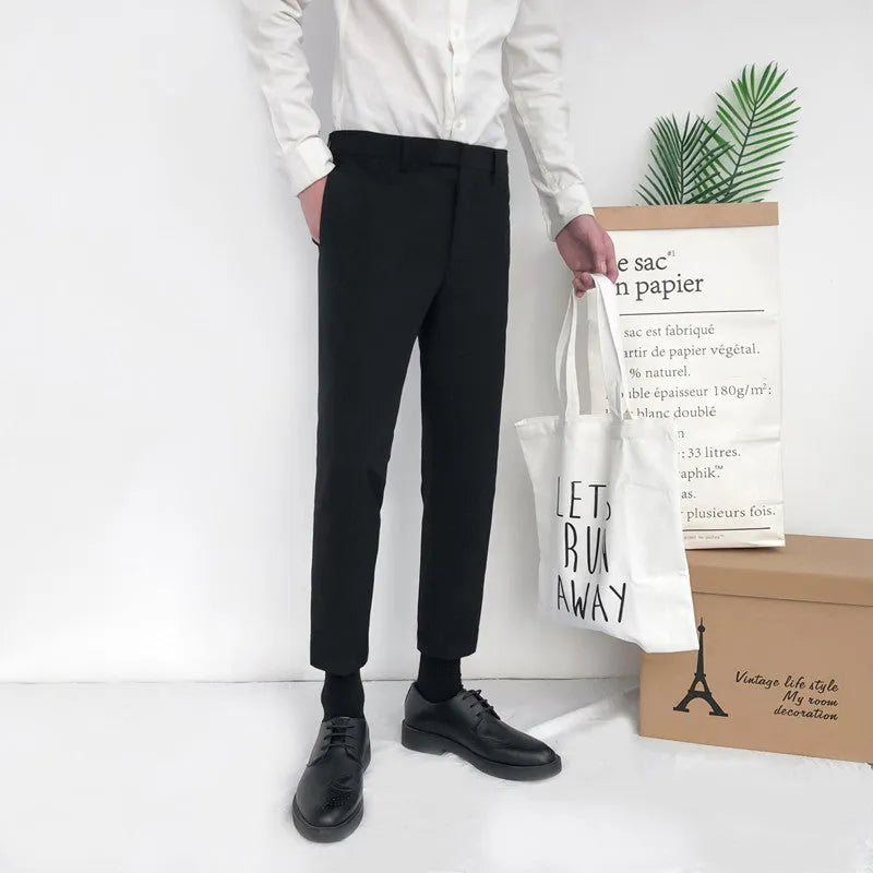 Man wearing black slim straight-leg loose fit cotton trousers with a drawstring waist