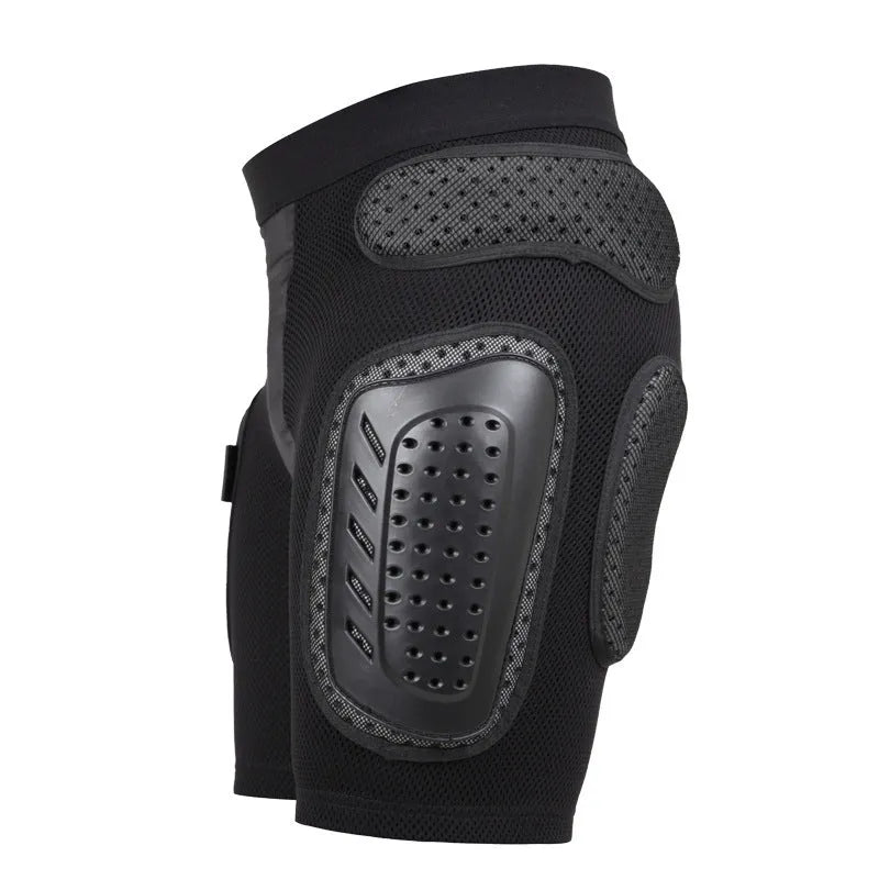 Black cycling hip protection pants shown laid flat, designed for impact safety during sports.