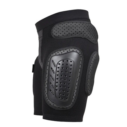 Black cycling hip protection pants shown laid flat, designed for impact safety during sports.