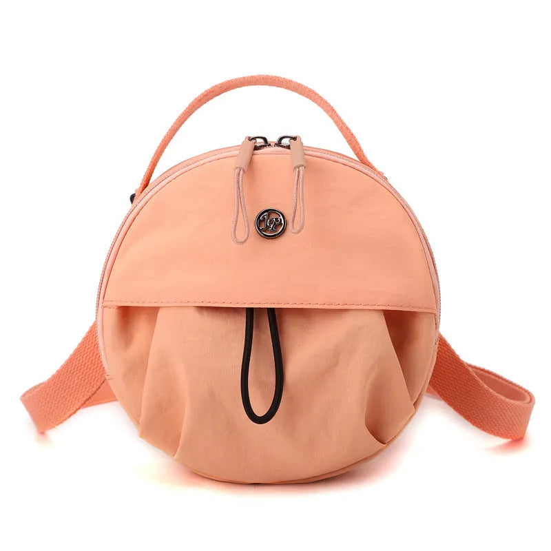Out shoulder crossbody messenger bag in nylon showing interior zipped changing bag, phone pocket, and document compartment.