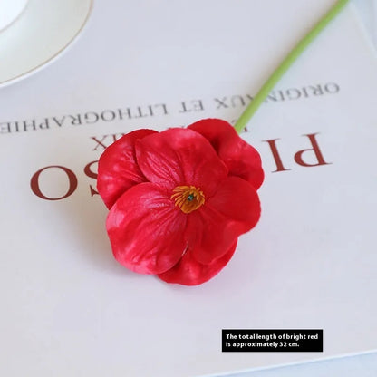 Pack of 15 mini artificial poppy flowers in assorted colours including purple, pink, yellow and red.