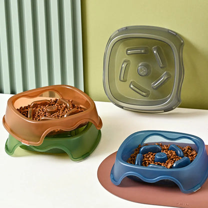 Blue plastic anti-choke slow feeder bowl for dogs on a floor