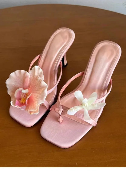 Women's handmade asymmetric flower high heel sandals in black, green, pink, or white on a calf leather upper with EVA sole.