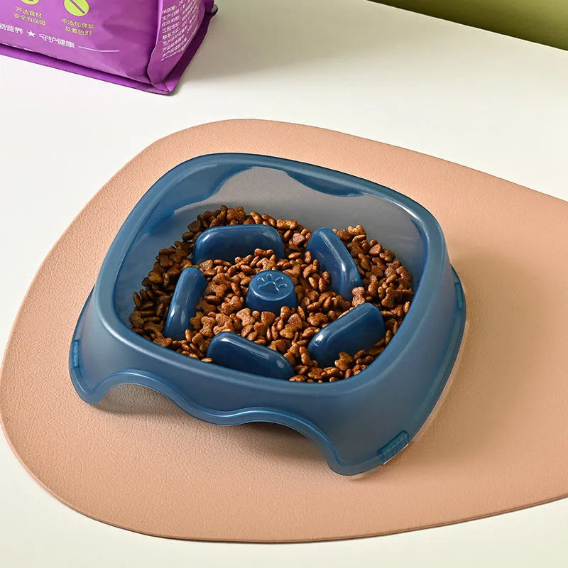 Blue plastic anti-choke slow feeder bowl for dogs on a floor