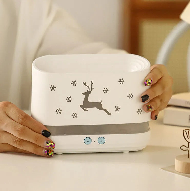 White round Elk flame effect humidifier and essential oil diffuser on a surface with mist and light on.