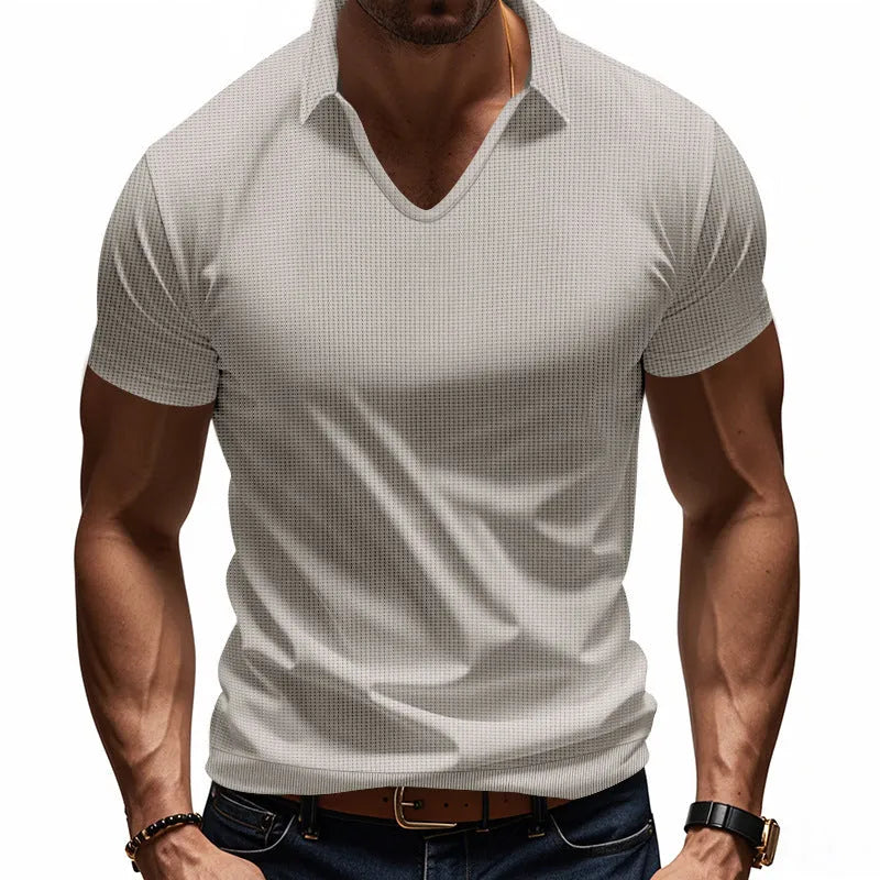 Man modelling a loose-fit apricot coloured V-neck short-sleeve T-shirt for casual summer wear.